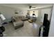 Inviting living room with tile floors, a cozy sectional sofa, neutral walls and a cat tree for furry friends at 2007 N 55Th Ln, Phoenix, AZ 85035