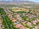 An aerial view of a neighborhood featuring a green common area, with scenic mountain views at 20639 W Grandview Dr, Buckeye, AZ 85396
