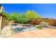 Desert landscaping with a variety of colorful flowering bushes, green shrubs and decorative rock ground cover at 20639 W Grandview Dr, Buckeye, AZ 85396