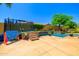 Backyard oasis with a built in trampoline, inground pool, custom stonework and desert landscaping elements at 20639 W Grandview Dr, Buckeye, AZ 85396