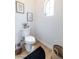 Bright powder room with modern fixtures, warm wood flooring, and charming decor at 20639 W Grandview Dr, Buckeye, AZ 85396