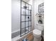 A modern bathroom with white subway tile and black hardware featuring a walk-in shower and elegant fixtures at 20639 W Grandview Dr, Buckeye, AZ 85396