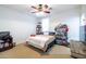 A well-lit bedroom featuring a ceiling fan, shelves, and displays offering a comfortable and personalized living space at 20639 W Grandview Dr, Buckeye, AZ 85396