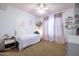 A charming bedroom with a pink ceiling, a daybed with curtains, and a ceiling fan features soft, inviting colors at 20639 W Grandview Dr, Buckeye, AZ 85396