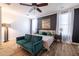 Stylish bedroom with a modern couch, a ceiling fan, and natural light from large windows at 20639 W Grandview Dr, Buckeye, AZ 85396