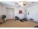 Large bonus room provides versatile space, and features a ceiling fan, and wood laminate flooring at 20639 W Grandview Dr, Buckeye, AZ 85396