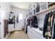 A spacious walk-in closet with custom shelving, drawers, and hanging rods offers ample storage for clothing and accessories at 20639 W Grandview Dr, Buckeye, AZ 85396