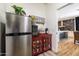 Coffee Bar with stainless mini-fridge next to a red cabinet at 20639 W Grandview Dr, Buckeye, AZ 85396