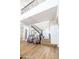 Bright foyer features wood floors, staircase with iron railing, and seating area with stylish armchairs at 20639 W Grandview Dr, Buckeye, AZ 85396