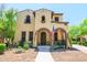Charming two-story home showcases a well maintained front yard with mature plantings and an arched front porch at 20639 W Grandview Dr, Buckeye, AZ 85396