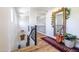 Bright and airy hallway with wood floors, decorative rug, and an ornate mirror at 20639 W Grandview Dr, Buckeye, AZ 85396