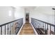 Upstairs hallway featuring hardwood floors and ornate wrought iron railings at 20639 W Grandview Dr, Buckeye, AZ 85396
