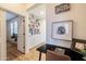 A home office features built-in bookshelves, a black desk, and stylish decor offering a comfortable workspace at 20639 W Grandview Dr, Buckeye, AZ 85396