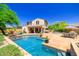 Relaxing backyard with a sparkling pool, patio furniture, and lush landscaping, ideal for outdoor living at 20639 W Grandview Dr, Buckeye, AZ 85396