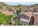 Expansive aerial view shows a backyard patio, lush greenery, and many neighboring homes with red-tiled roofs at 2114 E Escuda Rd, Phoenix, AZ 85024