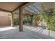 Charming covered patio with swing, perfect for enjoying the lush backyard at 2114 E Escuda Rd, Phoenix, AZ 85024