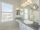 Bright bathroom featuring a large vanity, granite countertop, and a well-lit mirror with decorative mosaic backsplash at 2114 E Escuda Rd, Phoenix, AZ 85024