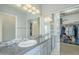 Spacious bathroom featuring dual sinks, granite counters, mosaic tile backsplash and open access to the walk-in closet at 2114 E Escuda Rd, Phoenix, AZ 85024