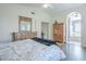 The bedroom includes wood furniture and access to the en suite bathroom at 2114 E Escuda Rd, Phoenix, AZ 85024