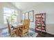 Dining room with a large window, table seating six, and a china cabinet at 2114 E Escuda Rd, Phoenix, AZ 85024