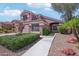 Charming two-story home with a well-manicured lawn and walkway to the entrance at 2114 E Escuda Rd, Phoenix, AZ 85024