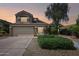Two story home at dusk with a two car garage and mature landscaping at 2114 E Escuda Rd, Phoenix, AZ 85024