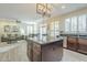 Open kitchen view with island, stainless appliances, and hardwood flooring flowing into the living room at 2114 E Escuda Rd, Phoenix, AZ 85024