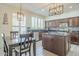 Well-lit kitchen featuring stainless steel appliances, granite countertops, and a dining area at 2114 E Escuda Rd, Phoenix, AZ 85024
