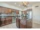 Spacious kitchen featuring dark wood cabinetry, granite countertops, and stainless-steel appliances at 2114 E Escuda Rd, Phoenix, AZ 85024