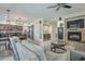 Open-concept living room featuring a fireplace, comfortable seating, and seamless flow into the kitchen area at 2114 E Escuda Rd, Phoenix, AZ 85024