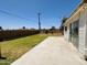 Wide view of backyard with lawn and block wall providing privacy at 2115 W Myrtle Ave, Phoenix, AZ 85021