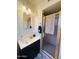 Bathroom vanity featuring a white sink, gold fixtures and a glass shower at 2115 W Myrtle Ave, Phoenix, AZ 85021