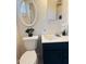 Bathroom featuring an updated toilet, sink, fixtures and an oval mirror at 2115 W Myrtle Ave, Phoenix, AZ 85021