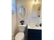 Bathroom featuring an updated toilet, sink, fixtures and an oval mirror at 2115 W Myrtle Ave, Phoenix, AZ 85021