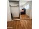The bedroom boasts wood-look floors and mirrored closet doors for added appeal at 2115 W Myrtle Ave, Phoenix, AZ 85021