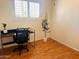 Bright bedroom featuring a modern desk, chair, and window with plantation shutters at 2115 W Myrtle Ave, Phoenix, AZ 85021