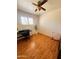 A well-lit bedroom featuring wood floors, a ceiling fan, and a window at 2115 W Myrtle Ave, Phoenix, AZ 85021