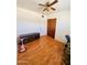 Bedroom with ceiling fan, laminate wood flooring and updated closet doors at 2115 W Myrtle Ave, Phoenix, AZ 85021
