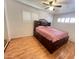 Bedroom featuring wood-look floors, shutters, and a storage bed with drawers at 2115 W Myrtle Ave, Phoenix, AZ 85021