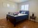 Bright bedroom with wood floors and shuttered windows, perfect for relaxation and comfort at 2115 W Myrtle Ave, Phoenix, AZ 85021