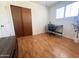 Bedroom featuring wood-look floors, a desk, and a closet with wood sliding doors at 2115 W Myrtle Ave, Phoenix, AZ 85021