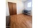 Bedroom with wood-look flooring, neutral walls, and a closet with sliding doors at 2115 W Myrtle Ave, Phoenix, AZ 85021