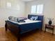 Well-lit bedroom with wood floors and shuttered windows, offering a serene retreat at 2115 W Myrtle Ave, Phoenix, AZ 85021