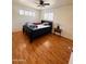 Bedroom featuring wood-look floors, shutters, and a ceiling fan at 2115 W Myrtle Ave, Phoenix, AZ 85021