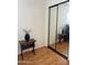 Bedroom with mirrored closet doors and wood floors, creating a spacious and modern feel at 2115 W Myrtle Ave, Phoenix, AZ 85021