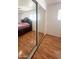 The bedroom boasts wood-look floors and mirrored closet doors for added appeal at 2115 W Myrtle Ave, Phoenix, AZ 85021