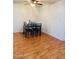 Bright dining area featuring a ceiling fan and a dark wood table set for four at 2115 W Myrtle Ave, Phoenix, AZ 85021