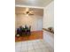 View of a dining area with a black table and chairs, wood floors, and a partial view of the kitchen at 2115 W Myrtle Ave, Phoenix, AZ 85021