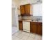 Kitchen featuring wood cabinets, a white dishwasher, and a double stainless steel sink at 2115 W Myrtle Ave, Phoenix, AZ 85021