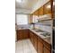 Functional kitchen with wooden cabinets, gas range, and tiled backsplash at 2115 W Myrtle Ave, Phoenix, AZ 85021